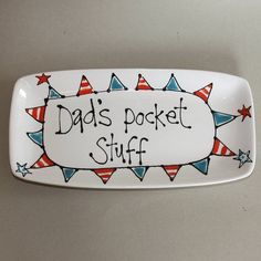 a white plate that says dad's pocket stuff with red, white and blue stars on it