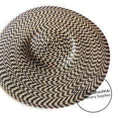 This black and straw polybraid cartwheel hat base is a classic shape that has sprung into popularity in the past year. Made from polybraid that has been spiralled and blocked, it has a petershams ribbon sewn into the inside crown for stability. Simply trim and add a comb or headband for securing to the head and your done!Measures:Width: 35cm (13.7 inches)Crown height: 2.5cm (1 inch)For even more millinery supplies you can find us here:www.etsy.com/shop/PetershamsAll orders are posted daily from Black Woven Brimmed Sun Hat, Black Handmade Flat Brim Sun Hat, Handmade Black Flat Brim Sun Hat, Adjustable Black Woven Straw Hat, Black Woven Sun Hat With Flat Brim, Black Handmade Sun Hat With Curved Brim, Handmade Black Hat Bands For Summer, Black Woven Flat Brim Sun Hat, Handmade Black Mini Hat For Beach