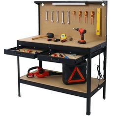 an open toolbox with tools in it on a workbench, ready to be used