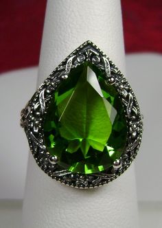 Simulated Peridot Ring Description Tear Vic Design#28 MADE TO ORDER Inspired by Victorian and Art Deco designs I now offer this Antique reproduction in sterling silver. This gorgeous ring is set with an 8ct pear cut flawless Simulated Green Peridot gemstone. The gem is 16mm (approx. 5/8th of an inch) by 12mm (just shy of 1/2th inch) in dimension... The inside of the band is marked 925 for sterling. Notice the beautiful filigree swirl like the craftsmanship of the silver setting. This is an exqui Classic Pear-shaped Green Ring, Classic Green Pear-shaped Ring, Teardrop Green May Birthstone Ring, Green Teardrop Ring For May Birthstone, Green Teardrop May Birthstone Ring, Classic Green Teardrop Emerald Ring, Classic Green Drop Jewelry, Teardrop Green Emerald Ring For Wedding, Green Teardrop Rings For Anniversary