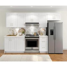 a kitchen with white cabinets and stainless steel appliances, including a silver refrigerator freezer