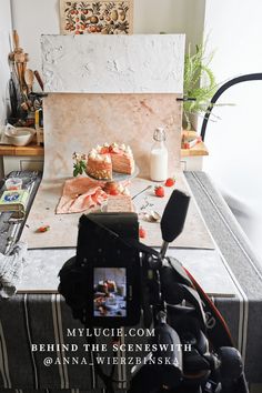 a table with food on it in front of a camera and some other items to be used