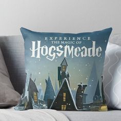 a throw pillow that reads experience the magic of hogwarte with houses in the background