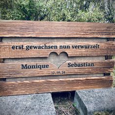 a wooden sign with the names of two different languages in german and english on it