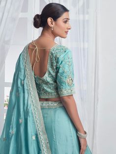 Introducing our precious sky-blue embroidered organza bridesmaid lehenga choli, a stunning ensemble that will make you stand out at any event or special occasion. This beautiful lehenga set features a sky-blue color organza lehenga with intricate multi-embroidered work and sequin detailing, paired with a matching choli and dupatta that also boasts beautiful embroidery and sequin work. The designer lace work on the dupatta adds an elegant touch to the overall look.
This lehenga choli set includes Embroidered Organza Choli For Wedding, Light Blue Semi-stitched Dress With Intricate Embroidery, Semi-stitched Light Blue Dress With Intricate Embroidery, Light Blue Semi-stitched Resham Embroidery Lehenga, Light Blue Saree Dress For Wedding, Unstitched Blouse Lehenga In Organza For Navratri, Organza Lehenga With Unstitched Blouse For Navratri, Navratri Organza Lehenga With Unstitched Blouse, Light Blue Zari Work Wedding Gown