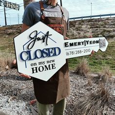 a man holding up a sign that says it's closed on my new home