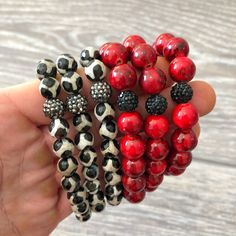 Red beads with black veining strung with black rhinestone beads on elastic cord. The bracelet measure 7 inches around. This listing is for one bracelet only.  Find our full selection of bracelets in our shop at https://www.etsy.com/shop/Immeasurablymore2 Follow Immeasurably More on Instagram immeasurablymore_) for special announcements, coupon codes, and giveaways. Cheap Red Beaded Bracelets For Festivals, Affordable Red Beaded Bracelets As Gifts, Cheap Handmade Red Stretch Bracelet, Luxury Red Handmade Beaded Bracelets, Cheap Red Beaded Bracelets, Luxury Red Beaded Bracelets With Round Beads, Stretchy Beaded Bracelet Red Instead, Red And Black Bracelets, Immeasurably More