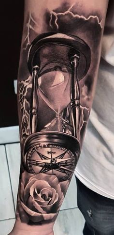 a man's arm with an hourglass and rose tattoo on the left forearm