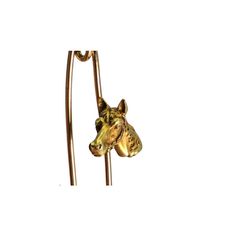 a golden dog head hanging from a metal hook on a white background with clippings