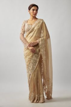 Champagne gold tulle and tissue silk saree with pearls, crystals and glass beaded hand embroidery. Comes with a padded blouse and an underskirt. - Aza Fashions Embellished Tissue Silk Blouse Piece For Wedding, Wedding Embellished Tissue Silk Blouse Piece, Hand Embellished Saree Blouse Piece For Wedding, Hand Embellished Blouse Piece For Wedding Saree, Wedding Embellished Chanderi Blouse Piece, Gold Silk Pre-draped Saree With Intricate Embroidery, Gold Organza Pre-draped Saree With Resham Embroidery, Gold Embellished Tissue Silk Saree, Hand Embellished Pre-draped Saree For Wedding