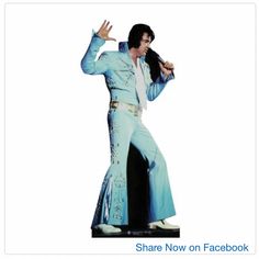 elvis presley standing on stage with his hands in the air, wearing blue and white clothing