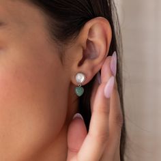 Discover the enchanting beauty of the land and sea with our Jade Heart Drop Earrings ✨ Featuring a lustrous Mother of Pearl and vibrant Jade gemstone, these earrings add a sophisticated pop of color to any look, a must-have for those who appreciate nature-inspired jewelry. SKU: RR-ER542 Product Details Material: High Quality Solid 925 Sterling Silver Finish: 18K Gold ∙ Sterling Silver Featuring dainty Stud Earrings with a ~8mm Mother of Pearl and ~8mm dangling Jade Heart Gemstone Sold as a pair Elegant Dangle Heart Earrings For Her, Elegant Dangle Heart Earrings As Gift For Her, Elegant Heart Shaped Natural Stone Jewelry, Elegant Heart-shaped Natural Stone Jewelry, Dangle Pearl Earrings With Gemstones, Elegant Green Earrings With Heart Charm, Elegant Green Heart Earrings For Gift, Elegant Gemstone Heart Drop Earrings, Elegant Teardrop Earrings With Heart Charm