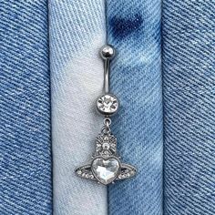 the belly button is attached to a pair of jeans with a jeweled star on it