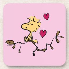 a cartoon dog is sitting on a branch with hearts in the air beverage coasters