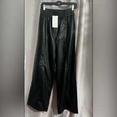 Size Small High Waisted Elastic Waistband Wide, Flared Leg Two Front Slant Pockets Two Back Welt Pockets Solid Black Faux Leather Polyester/Polyurethane Black Waist: 13" Rise: 13" Inseam: 21 New With Tags Zara Faux Leather Pants, Zara Jumpsuit, Faux Leather Pants, Zara Pants, Zara Black, Black Faux Leather, Welt Pockets, Solid Black, Pant Jumpsuit