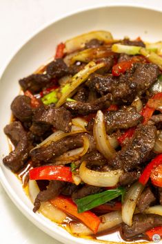 a white plate topped with meat and vegetables