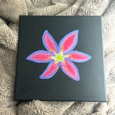 a black box with a pink flower painted on it