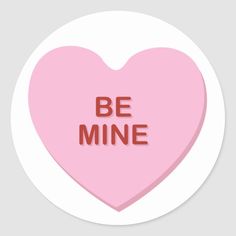 a pink heart shaped sticker with the words be mine in red letters on it