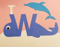 the word w is made out of paper with a whale and dolphin on it