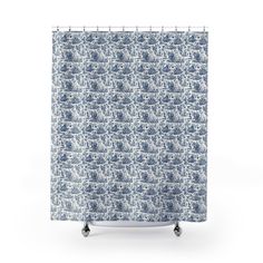 a shower curtain with blue and white waves on it, in front of a white background