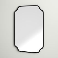 Bring a dynamic look to your bathroom or hallway with this wall-hanging mirror. Crafted with an engineered wood frame, its design features clean, curved lines and a rectangular silhouette, complete with notched corners for a subtle art deco look. We love that its solid hue finish shows off a glossy look that pairs well with any decor aesthetic or color scheme. Plus, the mirrored surface shows off beveled edges, adding a traditional element. Best of all, it comes with hanging hardware that lets y Rectangle Wall Mirror, Glossier Look, Hanging Wall Mirror, Curved Lines, Decor Aesthetic, Hanging Mirror, Beveled Edge, White Wood, Wall Mirror