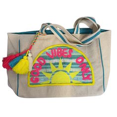 Carry your beach, pool, or lake essentials in style with this "Good Vibes Only" tote bag. Embroidered yarn detail and fun, bright colors add a playful touch to any beach day. Spread positive vibes wherever you go - only good vibes allowed! 21” x 15.5” Sunshine Patch Beach Tote Snap Closure Fun Decorative Tassels Canvas fabric Over the shoulder straps Interior Pockets Casual Embroidered Tote Beach Bag, Summer Canvas Shoulder Bag For Beach, Trendy Embroidered Summer Bag, Embroidered Beach Bag For Travel, Summer Canvas Shoulder Bag For Vacation, Bohemian Summer Canvas Bag, Embroidered Canvas Bag Casual Summer Style, Embroidered Casual Canvas Bag For Summer, Casual Multicolor Canvas Bag For Summer