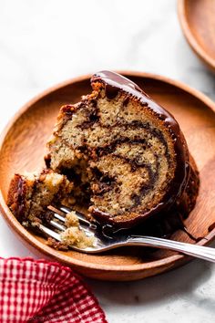 a chocolate swirl bundt cake on a plate with a bite taken out of it