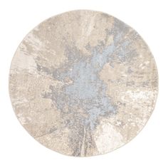 a round rug with blue and white designs on the top, in front of a white background