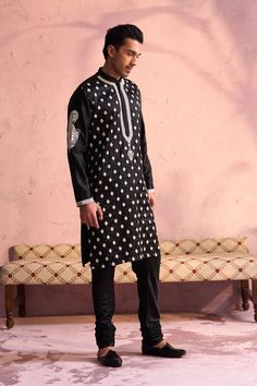 SHRESTHA By VASTRAMAY Men's Black Silk Embroidered Ethnic Kurta Pyjama Set Look dapper in this black silk blend kurta pyjama set featuring intricate embroidery. The kurta has a mandarin collar, full sleeves, and knee length. Pair it with the cream colored pajama for a complete and stylish ensemble. Dry clean only. Key Features Black silk blend fabric with embroidery Mandarin collar kurta with full sleeves Knee-length kurta with side pockets Cream colored pajama with elasticated waistband Specifi Collar Kurta, Kurta Pyjama, Looking Dapper, Intricate Embroidery, Sleeveless Jacket, Full Sleeves, Pyjama Set, Embroidered Silk, Mandarin Collar