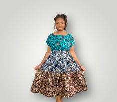 This is a 3-tiered Dress with 3 different matching African Prints. It is about colorful, fun and comfortable! Great for summer time and ideal will for your special event, or regular outing. The dress has 2 inner pockets for more comfort and practicality. Dress on Model is available and ready to be shipped. Model is 5.0ft and wears a US Medium. On request, this style can be custom made to your size and fabric preference. Just get in touch.  We will do all we can to ensure you love your dress and promptly address any additional requests you may have. Thanks in advance for your order! Bohemian Tiered Dress With Short Sleeves, Bohemian Short Sleeve Tiered Dress, Multicolor Floral Print Tiered Dress, Multicolor Tiered Dress With Ruffles, Bohemian Short Sleeve Flowy Tiered Dress, Fitted Green Tiered Dress, Flowy Multicolor Tiered Skirt Dress, Fitted Bohemian Tiered Dress, Bohemian Blue Tiered Skirt Dress