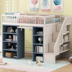 a child's bedroom with a loft bed and bookcases on the floor