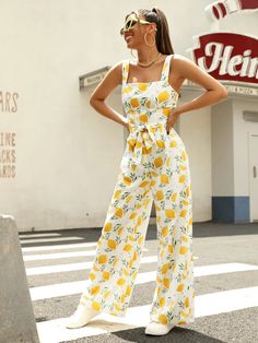 Allover Lemon Print Belted Jumpsuit is perfect for the free-spirited boho look, it features a fun and fresh fruit and vegetable all-over print with a comfortable and loose fit. The high-waist cut elongates your legs, while the belted waist cinches you in for a flattering silhouette. The zipper detail adds a touch of practicality, and the non-stretch fabric keeps its shape wash after wash. Perfect for any occasion, from picnics to festivals. Get ready to turn heads with this unique piece, exclusively from Comfy Jumpsuits. Specifications: Style: Boho Pattern Type: Fruit & Vegetable, All Over Print Type: Cami Details: Belted, Zipper Length: Long Fit Type: Loose Neckline: Straps Sleeve Length: Sleeveless Waist Line: High Waist Fabric: Non-Stretch Material: Fabric Composition: 100% Polyester Ca Trendy Cotton Jumpsuits And Rompers For Vacation, Summer Jumpsuit With Tie Waist For Day Out, Spring Cotton Jumpsuits And Rompers For Vacation, Spring Vacation Cotton Jumpsuits And Rompers, Summer High-waist Vacation Jumpsuit, Summer High-waist Jumpsuit For Vacation, Summer High Waist Vacation Jumpsuit, Trendy Wide Leg Jumpsuits And Rompers For Summer, Summer Relaxed Fit Jumpsuit