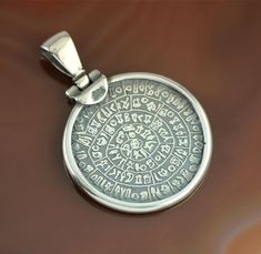 Phaistos Disc silver pendant, Phaistos Disc pendant, Phaistos necklace, antique coin pendant, coin necklace, Greek jewelry, bohemian pendant"Disc Phaistos" is a silver pendant representing the disc of Phaistos from Crete, dating from 1700 BC, the biggest mystery of the archaeological world.The Disc of Phaistos is one of the most famous mysteries of archeology. It is a disc of fired clay from the Minoan Palace of Phaistos on the Greek island of Crete. It is most likely dating from about 1700 BC.T Amulet Style Coin Pendant Jewelry, Sterling Silver Amulet Medallion Necklace, Engraved Amulet Medallion Necklace, Sterling Silver Coin-shaped Pendant, Spiritual Sterling Silver Engraved Medallion Necklace, Handmade Amulet Coin Necklace, Handmade Coin-shaped Amulet Jewelry, Engraved Coin-shaped Amulet Jewelry, Spiritual Coin-shaped Medallion Necklace With Locket