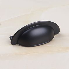 a black object sitting on top of a white counter