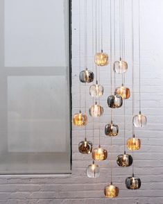 a chandelier made out of glass balls hanging from the ceiling