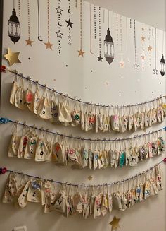 there are many bags hanging on the wall with star garlands attached to each one