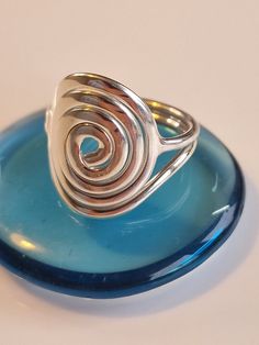 This is a beautifully handmade flat spiral ring, a stunningly simple design that is made with love and care.  This stunning statement ring is both light and easy to wear as well as being a very impressive and eye-catching design.   This ring comes gift wrapped and would make an ideal birthday gift, Valentine's Day Gift, Mother's Day Gift, anniversary gift or for any occasion. The spiral is the age-old intuitive symbol of spiritual development and our identity with the universe. It is found in cu Adjustable Spiral Ring With A Modern Twist, Adjustable Spiral Rings With A Modern Twist, Adjustable Spiral Ring With Modern Twist, Adjustable Swirl Ring As Gift, Handmade Spiral Minimalist Rings, Handmade Minimalist Spiral Rings, Minimalist Handmade Spiral Rings, Gift Spiral Ring With A Modern Twist, Modern Spiral Rings As A Gift