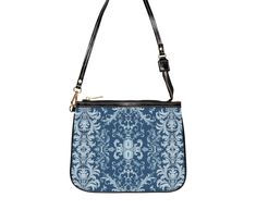 This unique and vibrant shoulder bag adds a chic touch to any outfit. Its compact size (10"w x 8"h) and lightweight construction makes it the perfect accessory for carrying around your essentials in style. Our one of a kind purse features an archival fabric design in baroque flourishes of sapphire, sky and pale blues. This gorgeous design is printed onto high-grade vegan leather and shipped to you by our top-rated production partner. We also offer the coordinating vegan wallet: https://thecheekyshedonist.etsy.com/listing/1680599038 .: 100% high-grade vegan leather exterior .: Polyester lining + 20-inch black strap .: Two open pockets inside .: Gold-toned zipper and hardware .: Original + unique art history design exclusively available at The Cheeky Shedonist  Care instructions: avoid prolo On-the-go Clutch Shoulder Bag With Detachable Handle, Elegant Zipper Pouch Bag For On-the-go, Trendy Zipper Pouch Shoulder Bag, Blue Shoulder Bag For Mobile Phone On-the-go, Trendy Satchel Shoulder Bag With Zipper Pouch, Blue Handheld Shoulder Bag For Everyday, Everyday Use Crossbody Evening Bag, Everyday Crossbody Evening Bag, Versatile Blue Pouch For Everyday Use