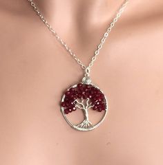 This beautiful Small size (Compare to my standard size) Red Garnet Tree of Life Pendant is hand wire wrapped with gorgeous Garnet gemstone using .925 Sterling Silver wires for the tree trunk and branches.  It is a beautiful gift to give or receive! January Birthstone, the symbol of Love ~~The pendant measures between 1.30  to 1.35 inch in diameter. The US quarter coin is about 1 inch(25mm) in diameter.  ~~The pendant  comes on an .925 Sterling Silver cable chain & finished with a .925 sterling silver lobster clasp.  ~~  Each pendant is handmade, so please allow slight variations from the shape of the branches and placement of the stones as shown ~~About GARNET gemstone:  The Garnet is a stone of purity and truth as well as a symbol of love and compassion. The Tree of Life is a universal sy Red Hand Wrapped Necklace As Gift, Red Hand Wrapped Necklace For Gift, Hand Wrapped Red Necklace As Gift, Spiritual Wire Wrapped Necklaces For Anniversary, Silver Plated Wire Necklaces With Gemstone For Gift, Gift Silver Plated Gemstone Necklace, Gift Silver Plated Wire Necklace With Gemstone, Gift Necklace With Gemstone On Silver Plated Wire, Sterling Silver Wire Wrapped Crystal Necklace