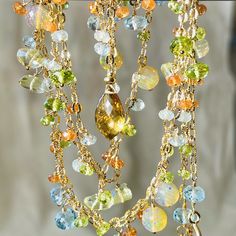 One of a kind, bohemian style, long and luxurious subtly hued lariat. This gold filled necklace is created with shimmery, textured chain adorned with lots and lots of dangles of mixed color, shape and size  beautiful faceted, exquisite quality gems. These gems are: whiskey quartz briolette, rounds of fiery Ethiopian opal, roundels of sky blue topaz, peridot and lemon quartz and smaller roundels of aquamarine, peridot and Spessonite, orange garnet. Arranged all around of the length of the necklac Bohemian Lariat Necklace With Gemstone For Jewelry Making, Bohemian Gemstone Lariat Necklace, Bohemian Lariat Necklace With Gemstone, Bohemian Citrine Gemstone Necklace, Bohemian Yellow Gold Briolette Jewelry, Bohemian Yellow Gemstone Jewelry, Bohemian Multicolor Briolette Jewelry, Lemon Quartz Necklace, Gold Filled Necklace