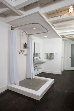 a bathroom with a shower, toilet and sink in it's center piece is shown