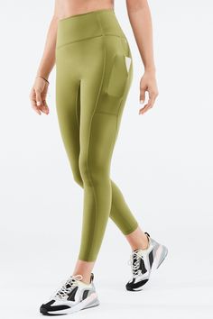 Trinity Motion365® HW Utility Legging Fabletics green female Activewear >> Womens >> Bottoms >> Leggings >> Full Length Motion365+ regular Training 4-Way Stretch/Chafe-Resistant/Moisture-Wicking/Pockets Multi-pocket legging in Motion365® fabric. Utility Leggings, Dark Green Leggings, Athleisure Leggings, Fitness Outfits, Buy Leggings, Fabletics Leggings, Purple Leggings, Camo Leggings, Ankle Leggings