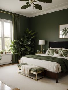 a bedroom with green walls and white carpeted flooring, large bed surrounded by potted plants