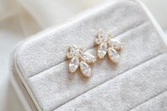 This pair of stunning rose gold cubic zirconia stud bridal earrings was meant to be worn by ladies on the most special day of their lives. Ever since we created the design for this elegant piece of jewelry, we imagined a romantic, modern bride wearing them as she walks down the aisle – and seeing them, we bet you can imagine yourself wearing them too!- Handcrafted with Premium cubic zirconia stones - All clear stones - Rhodium, yellow gold or rose gold finish- Earrings measures 1.25" x .625"- Ni Bridal Backdrops, Backdrops Necklace, Simple Rose, Bridal Bracelet, Clear Stone, Bride Wear, Modern Bride, A Romantic, Bridal Earrings