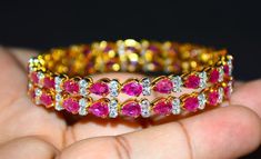 "1 solid 18k gold 10.35cts diamond and ruby bangle f-g color and vs clarity untreated natural diamonds and untreated natural pinkish red rubies. extremely high end - top quality bangle (i have 2 bangles, but this listing is of one bangle. please contact me if you are interested in both bangles) here is the description of one bangle: this is a custom made top quality ruby and diamond bangle. the bangle is loaded with 1.71cts of round brilliant cut diamonds and 22 pear cut natural red rubies total Yellow Gold Diamond Bangle For Party, Diamond Bangle In Yellow Gold For Party, Party Yellow Gold Diamond Bangle, Luxury Ruby Bangle Jewelry, Fine Jewelry Ruby Diamond Bangle Bracelet, Elegant Ruby Bangle With 17 Jewels, Luxury Ruby Bangle Gift, Diamond Prong Setting Bangle Gift, Diamond Bangle With Prong Setting Gift