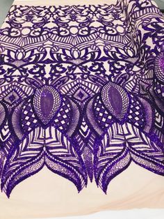 an image of a purple table cloth with intricate designs on the top and bottom edge