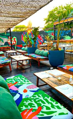 an outdoor seating area with colorful cushions and tables