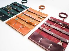 three different types of handmade leather jewelry cases