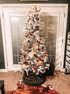 a white christmas tree with brown and silver decorations