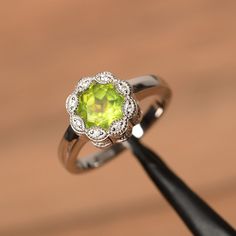 It is a natural peridot ring. The main stone is 7mm*7mm round cut, weight about 1.41 carats. The basic metal is sterling silver and plated with rhodium. To change the metal to a solid gold (white/rose) or platinum is also available, please ask for a quotation if you want. period is August birthstone. You can also go to my shop Home for more elegant rings: https://www.etsy.com/shop/godjewelry?ref=hdr_shop_menu More peridot rings: https://www.etsy.com/shop/godjewelry?ref=hdr_shop_menu§ion_id=20709 Square Cut Engagement Rings, Square Cut Rings, Peridot Rings, Unique Ring Designs, Peridot Engagement Rings, Elegant Rings, Square Engagement Rings, August Birthstone Ring, Pink Morganite Engagement Ring